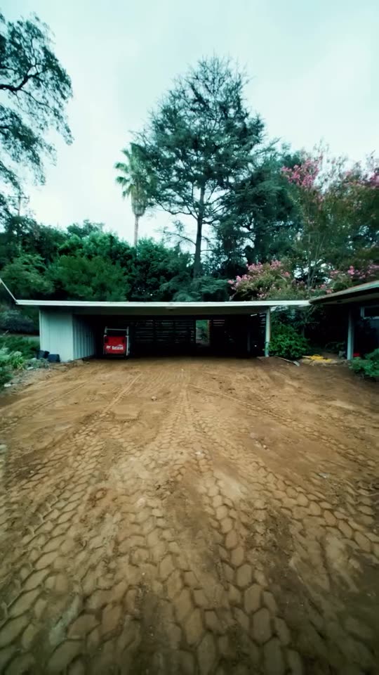 A cleared and graded front yard in front of a garage