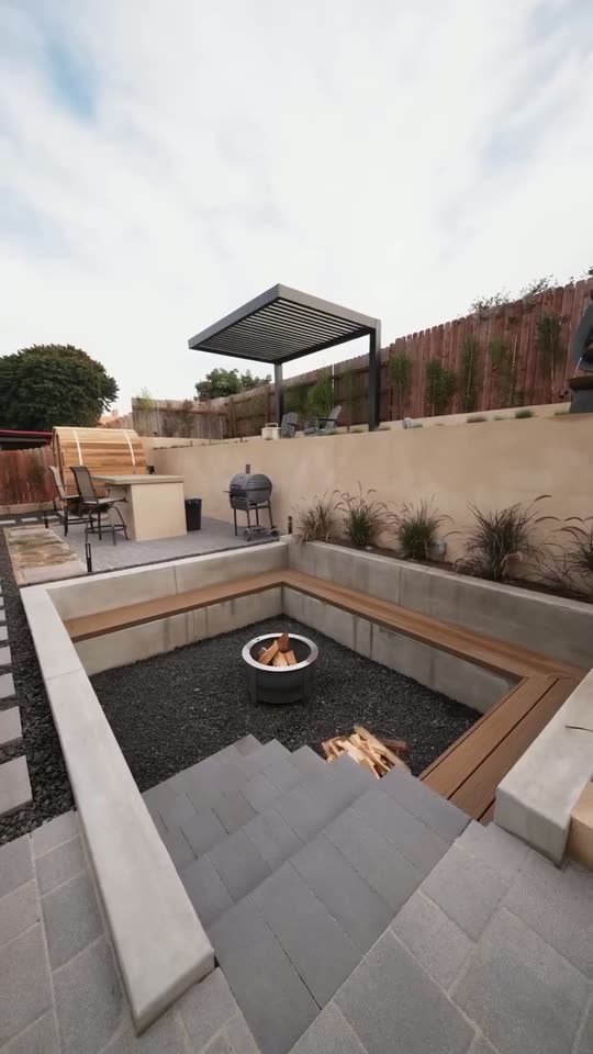 Steps down to a sunken fire pit lounge on a terraced hillside